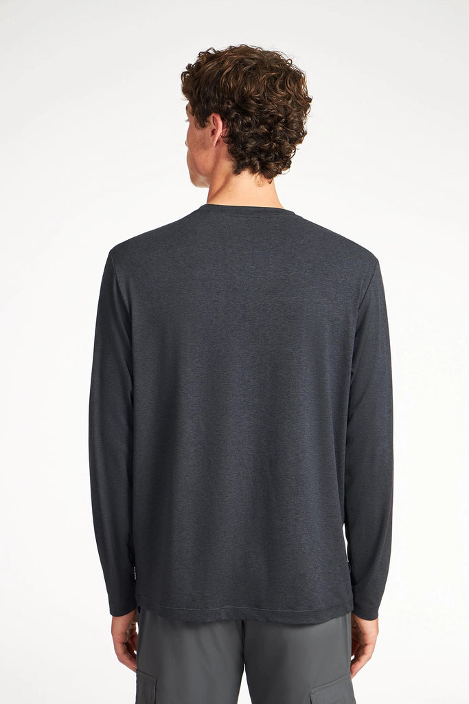 A man with short, curly brown hair is shown from the back, wearing a dark gray TECH APPAREL MENS BRUSHED SPACE DYE LONG SLEEVE TOP and gray pants against a plain white background.