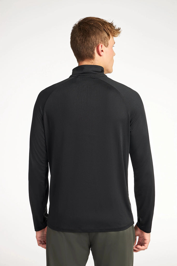 A person with short light brown hair stands with their back to the camera, wearing the TECH APPAREL MENS BRUSHED MARLED MOCK-NECK PULLOVER in black and olive green pants against a plain white background.