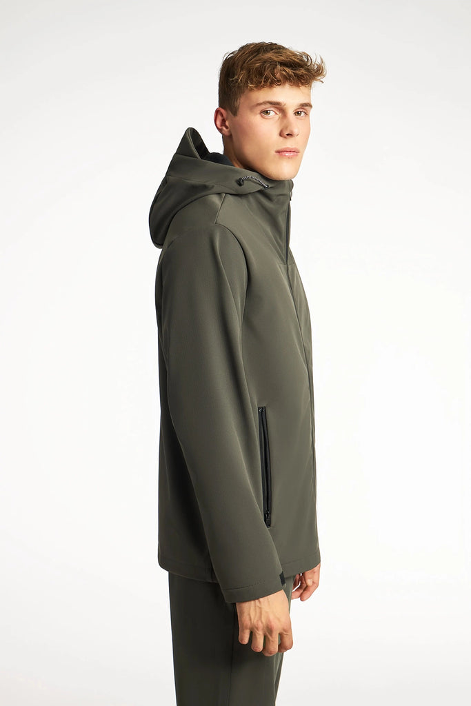 A young man with short hair models the TECH APPAREL MENS BONDED FLEECE JACKET and matching pants, standing sideways and looking at the camera against a plain white background.