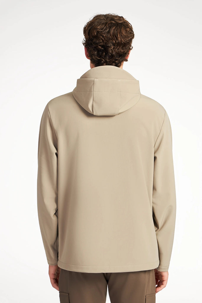 A person with short curly hair is shown from the back, wearing brown pants and a beige TECH APPAREL MENS BONDED FLEECE JACKET, standing against a plain white background.