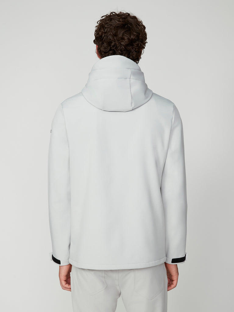 A person with curly hair is seen from the back, wearing a white TECH APPAREL MENS BONDED FLEECE JACKET and matching white pants against a plain, light background.