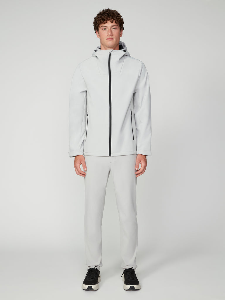 A person stands facing forward, wearing a light gray TECH APPAREL MENS BONDED FLEECE JACKET with matching pants and black sneakers against a plain white background.